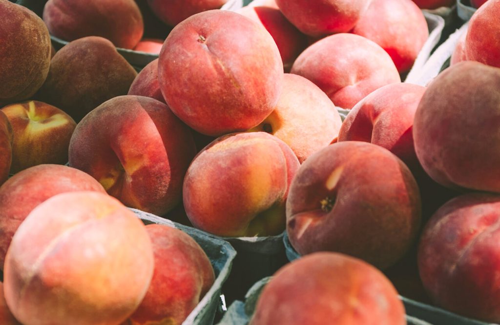 Wooden crate filled with fresh ripe peaches